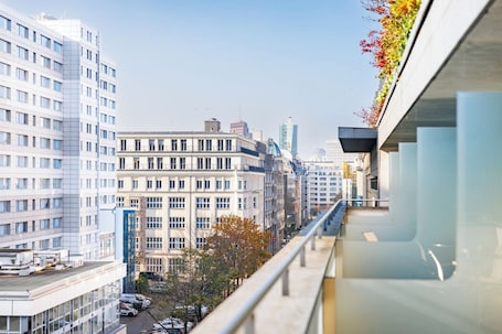 A high-rise building with a modern design, featuring large windows and a flat facade.