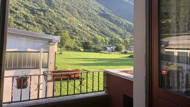 A balcony with a view of a green valley and mountains. - La Casa di Anna (Delebio)