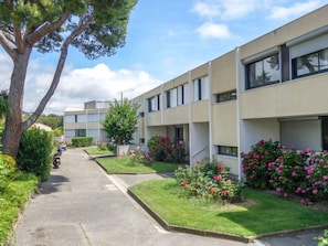 A row of modern, two-story buildings with a central pathway.