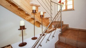 A staircase with wooden steps and metal railings, decorated with candles. - Beim Holzschnitzer by Interhome (Sölden)