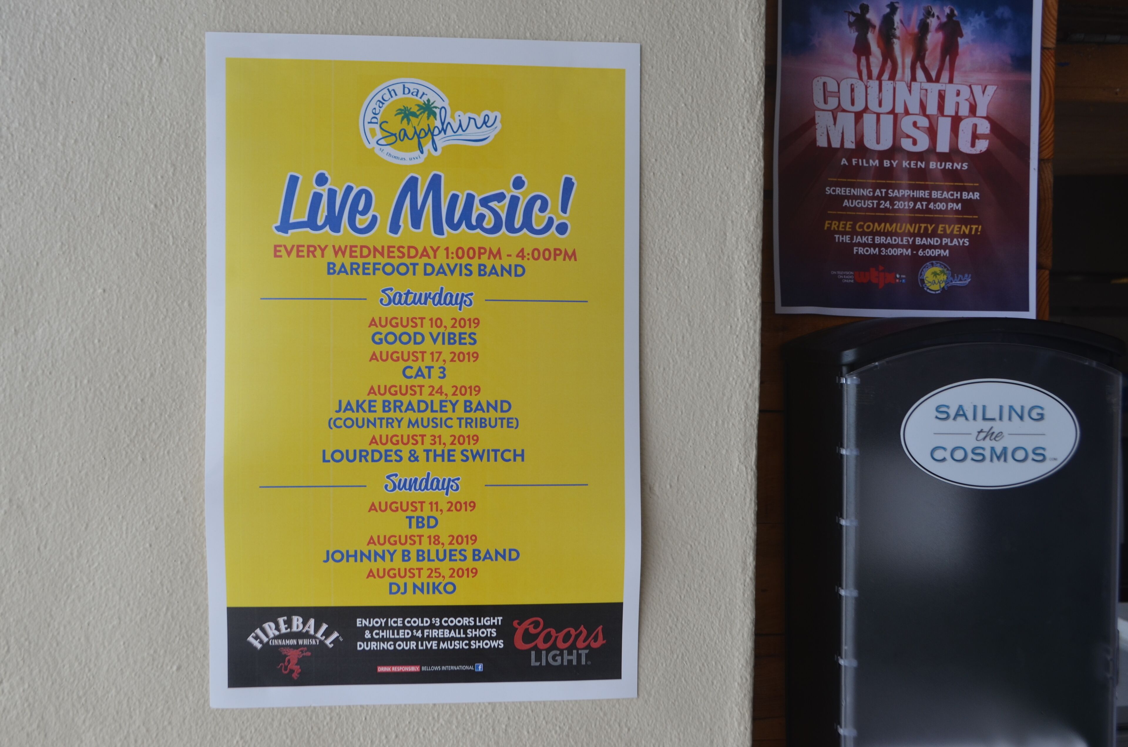 A wall with a poster advertising a live music event at a bar.