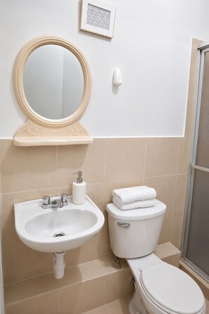 A bathroom with a sink, mirror, toilet, and a framed picture on the wall. - Moderno y Acogedor  3 Habitaciones  Cerca del Centro Histórico de Lima (Cercado de Lima)