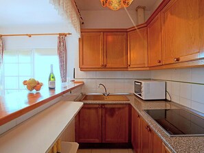 Fridge, oven, highchair, cookware/dishes/utensils