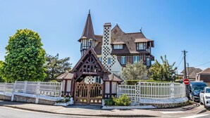A large, historic building with a prominent tower and a smaller annex. - Marie Antoinette by Interhome (Cabourg)