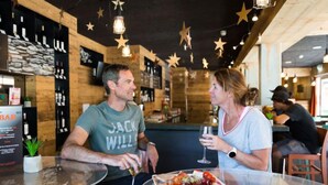 Un interior de restaurante con paredes de madera, decoraciones de estrellas y una zona de bar.