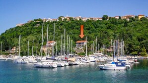 A marina with numerous boats docked, surrounded by a hillside with buildings. - Apartment Marija by Interhome (Krk/Omišalj)