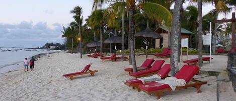 On the beach, sun-loungers