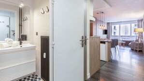 A modern bathroom with a white sink, towel rack, and a radiator. - Le Pramecou (Val Claret) by Interhome (Tignes)