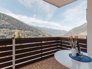 A balcony with a view of a mountainous landscape.
