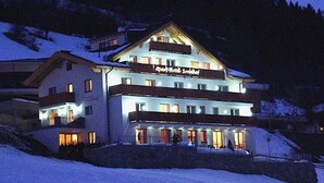A multi-story hotel with a sign reading "Apotheke Sonnhof" at the entrance. - Apartment Ladis by Interhome (Fiss)