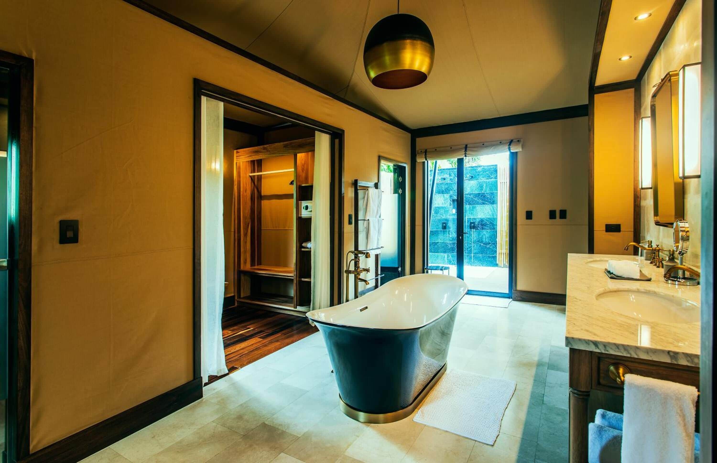 nayara tent | bathroom | combined shower/bathtub, rainfall showerhead, designer toiletries