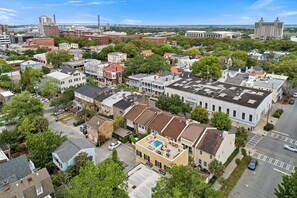 A residential area with a mix of single and multi-story houses, some with attached garages. - Broughton Street Villa with Rooftop Terrace, Garage Parking by Lucky Savannah (Savannah)