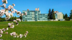 A modern building with multiple floors, large windows, and a flat roof. - Schau ins Land (B 97) by Interhome (Dittishausen)