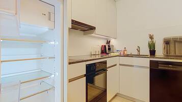 A modern kitchen with a built-in oven, a dishwasher, and a microwave.
