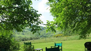 A patio with outdoor furniture, a potted plant, and a grill. - Vacation home Busani by Interhome (Salsomaggiore Terme)
