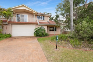 A two-story house with a garage, a balcony, and a well-maintained lawn. - Ajax Avenue, 6 (Nelson Bay)