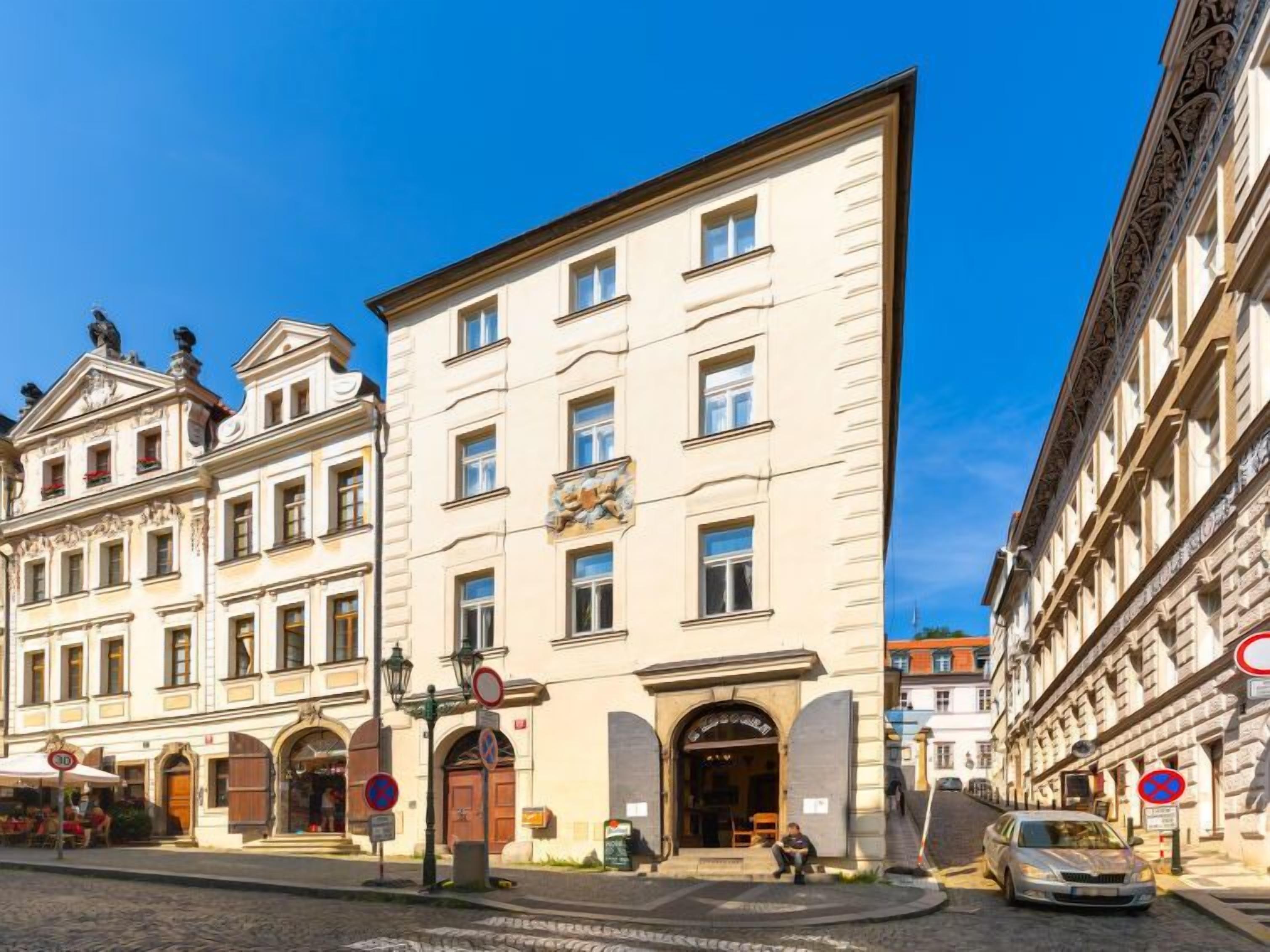 A historic building with a central entrance, multiple windows, and a decorative facade.