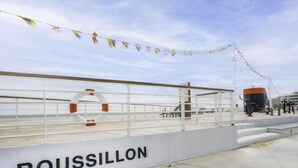 A deck with a railing, a lifebuoy, and the name 'ROUSSILLON' on the side. - Les Terrasses du Levant by Interhome (Canet-Plage)