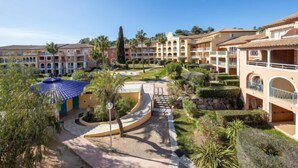 A resort with multiple-story buildings, a central courtyard with a fountain, and surrounding landscaped areas. - Les Rivages des Issambres by Interhome (Les Issambres)