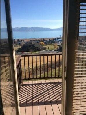 Enjoy breathtaking views of the distant water from this balcony.