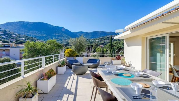 A rooftop terrace with a dining table, chairs, and potted plants. - Cap Marine by Interhome (Cavalaire)