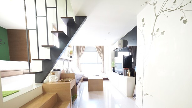 A modern interior with a staircase leading to a loft area, a flat-screen TV, and a minimalist design. - 5MIN to ATT 4 FUN (Taipei)