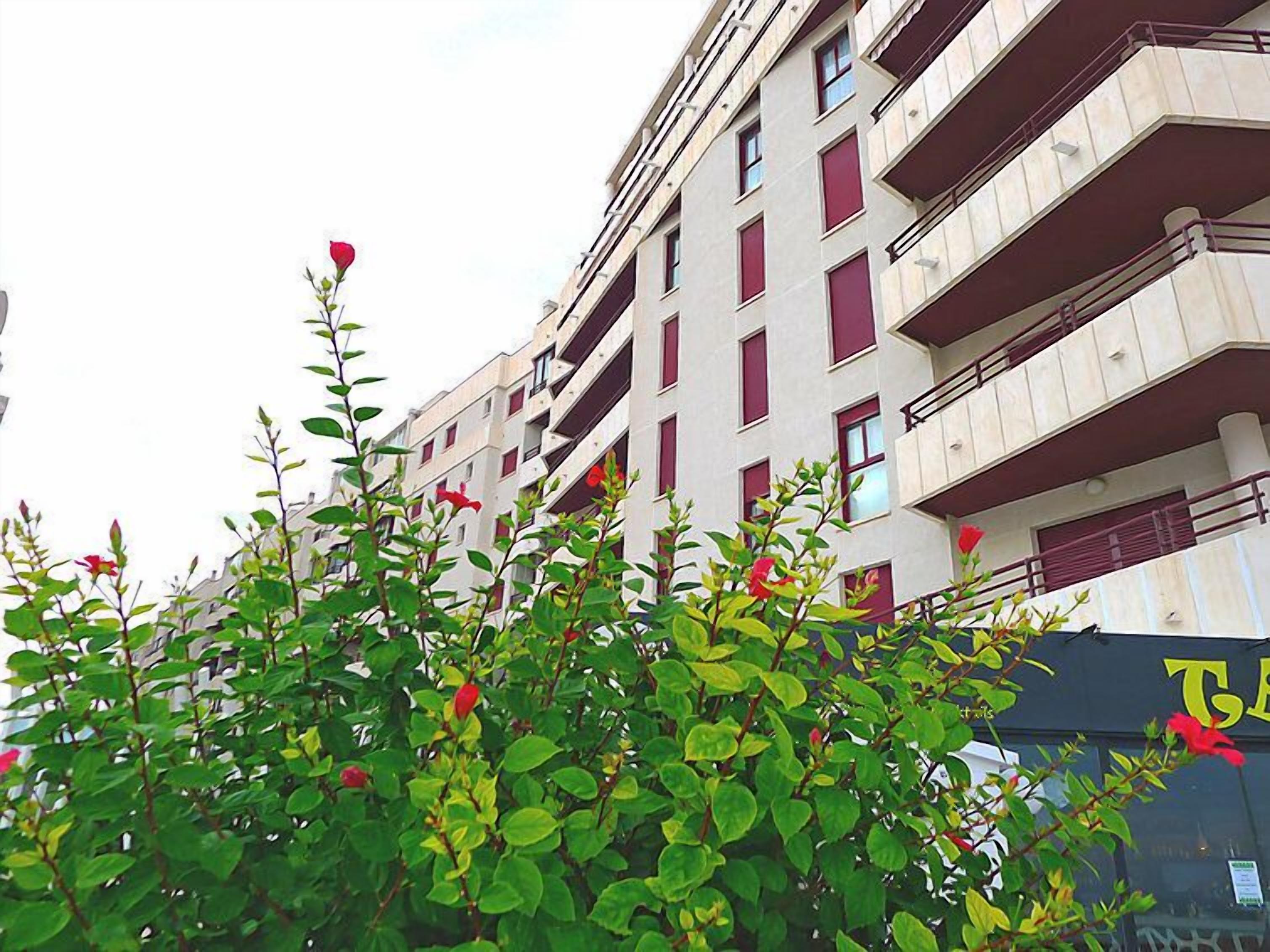 A multi-story building with balconies and windows.