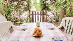 Una mesa para dos con mantel a cuadros, cuencos de vidrio transparente y un plato de pan.