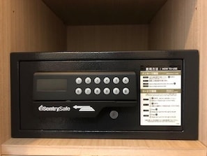 A black electronic device with a keypad and a screen, labeled 'SentrySafe,' in a wooden cabinet. - Sapporo Met S (Sapporo)