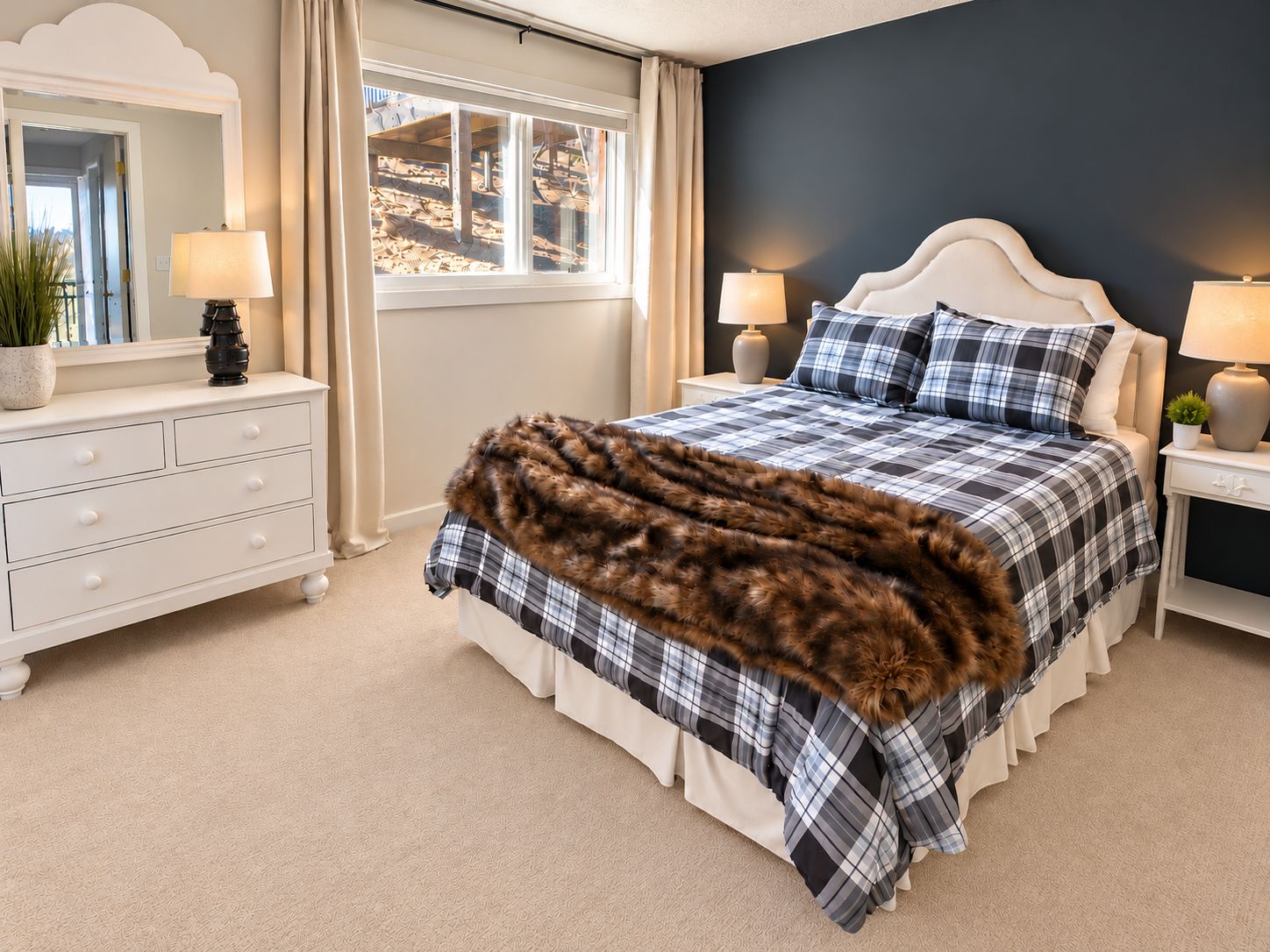 A bedroom with a bed, a dresser, two nightstands, and a window.