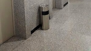 A hallway with three elevator doors, a trash bin, and a digital display on the wall. - Sea view Serviced Apartment 2 bedroom 2 bath #1 (Hawally)