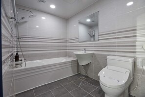 A modern bathroom with a bathtub, sink, and toilet. - Gloa Hotel (Hwaseong)