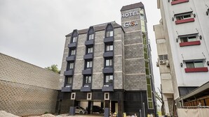 A multi-story hotel with a modern design, featuring a prominent sign on the top. - Gloa Hotel (Hwaseong)