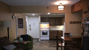 A compact living space with a kitchenette, a dining area, and a seating area. - Snowshed & Ramshead Ski Lodges in walking distance plus shuttle service (Killington)