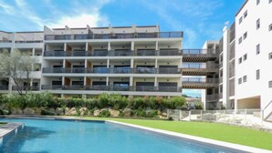 A modern hotel with a pool, multiple balconies, and a well-maintained garden. - Résidence Cita di Sali by Interhome (Porto Vecchio)