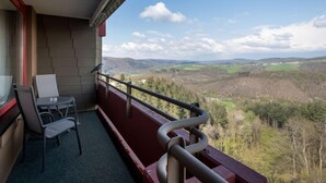 A balcony with a table and chairs, overlooking a mountainous landscape. - Luna (B901) by Interhome (Lahnstein (Koblenz))
