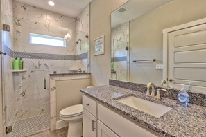 A bathroom with a shower, toilet, and sink. There is a sign on the wall that says "GO JUMP IN THE LAKE". - Canyon Lake Getaway | Private Hot Tub, Fire Pit, Game Room & Near River (Fischer)