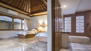 A bedroom with a bed, a nightstand, and a window with curtains. - Villa 6# 1BR Stunning Villa w/ Public pool at downtown Ubud (Ubud)