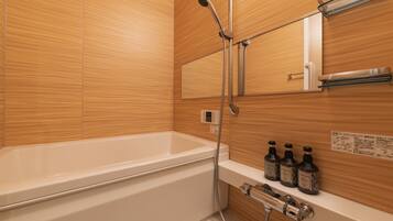 Separate bathtub and shower, free toiletries, hair dryer, slippers