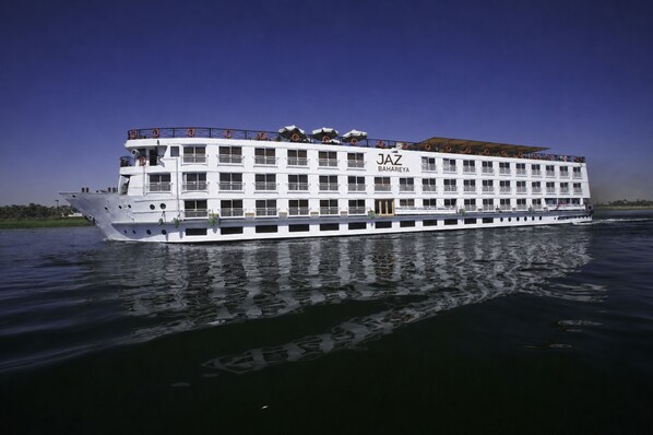 A large, multi-deck river cruise ship with balconies and a name 'JAZ BAHAREYA' visible. - JAZ Bahareya Nile Cruise - Every Saturday from Luxor for 07 &amp; 04 Nights - Every Wednesday From Aswan for 03 Nights (Luxor)