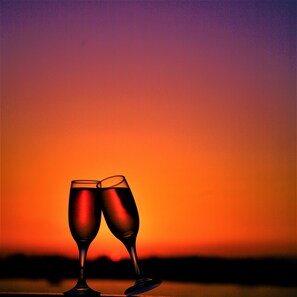 Two champagne flutes against a sunset background. - JAZ Bahareya Nile Cruise - Every Saturday from Luxor for 07 &amp; 04 Nights - Every Wednesday From Aswan for 03 Nights (Luxor)