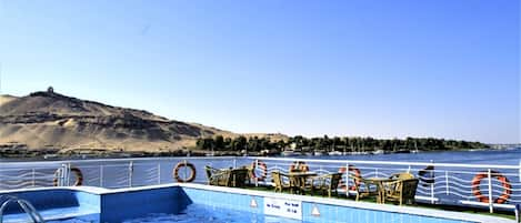 Outdoor pool, a rooftop pool, pool umbrellas, pool loungers