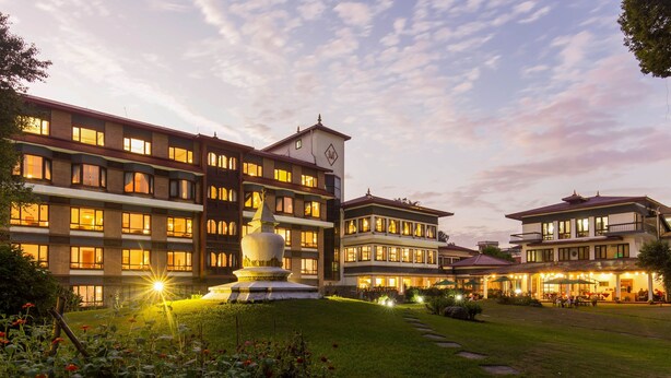 A multi-story hotel with a central courtyard, a fountain, and outdoor seating areas. - The Malla Hotel (Kathmandu)