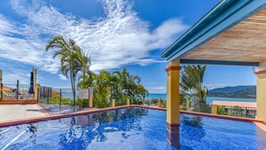 A clear blue sky, a swimming pool, and a view of the sea. - Ocean Views Galore - Airlie Beach (Cannonvale)