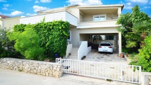 A two-story house with a car parked in the driveway. - Lastavica by Interhome (Vodice/Jadrija)