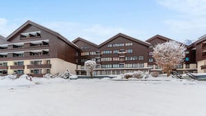 A multi-story hotel with a modern architectural design, featuring balconies and a snow-covered landscape. - Apartment Walter by Interhome (Bad Hofgastein)