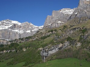 A mountainous landscape with snow-capped peaks and green valleys. - Ringstrasse Apt 423 by Interhome (Leukerbad)