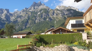 A mountain view with a wooden fence, stone steps, and a well-maintained lawn. - Edelweiss by Interhome (Werfenweng)