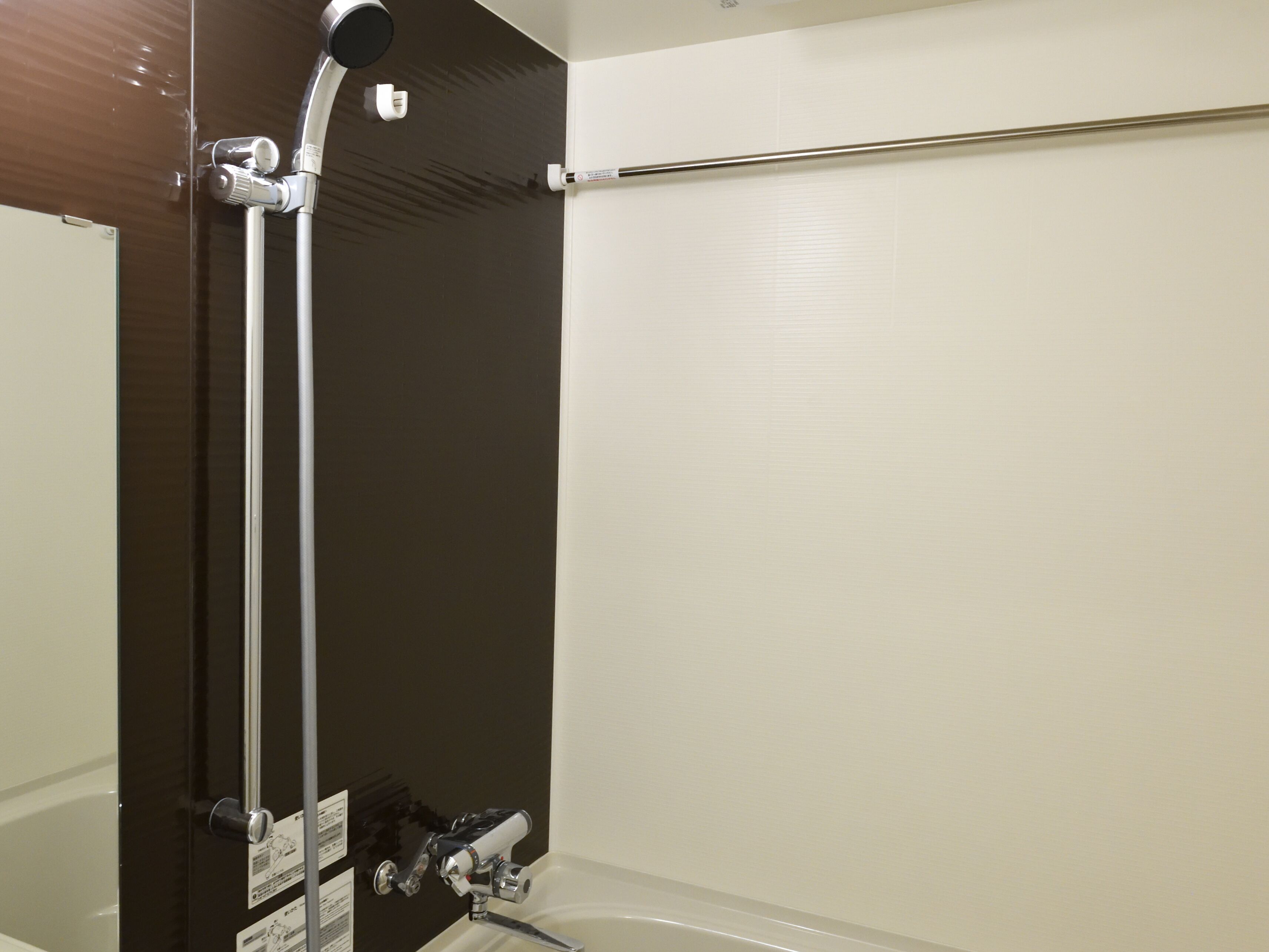A bathroom with a shower, a toilet, and a bathtub.