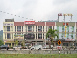 A row of commercial buildings with signs for S Z Hotel, EVO City Enterprise, and CK Hotel.